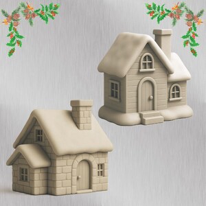 May include: Two beige miniature houses with snow-covered roofs and chimneys. One house has a brick facade, while the other has a wooden plank design. Both have arched doorways and small windows. Festive greenery decorates the top corners.