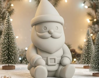 Op de afbeelding: Een lichtgrijze kerstmanfiguur met een hoed, baard en riem. De figuur zit op een besneeuwd oppervlak, omringd door kleine kerstbomen en ingepakte cadeaus. De achtergrond heeft een vage lichtslinger.