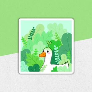 May include: A white goose with a green head and beak is peeking out from behind a cluster of green leaves. The goose is looking to the right of the image.