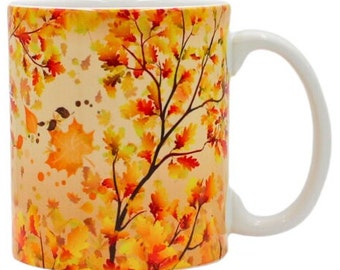 May include: A white ceramic mug with a colorful autumn leaf design. The mug features a pattern of orange, yellow, and red leaves on a cream background.