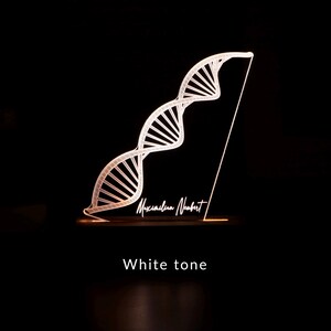 3D illusion lamp featuring a detailed DNA double helix design, illuminated in a white tone, personalized with a name, perfect as a unique and thoughtful gift for geneticists, scientists, or medical professionals specializing in human genome research