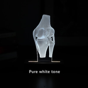 3D illusion lamp featuring a detailed human knee joint anatomy design, illuminated in a white tone, perfect as a unique and thoughtful gift for orthopedic specialists, physiotherapists, or medical professionals focusing on joint health.