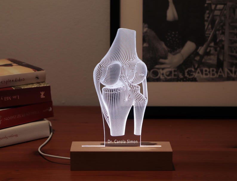 3D illusion lamp featuring a detailed human knee joint anatomy design, illuminated in a white tone, perfect as a unique and thoughtful gift for orthopedic specialists, physiotherapists, or medical professionals focusing on joint health.