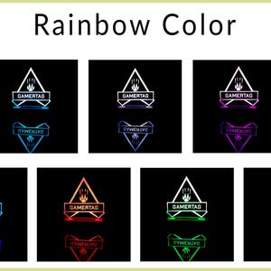 May include: A white triangle with the text "GAMERTAG" inside, with a paw print above the text. The triangle is illuminated with different colors, including red, blue, green, purple, and yellow. The text "DYWEBIVO" is below the triangle.