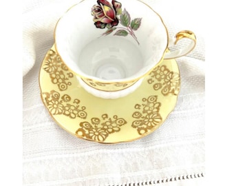Conjunto de xícara e pires WINDSOR, estampa floral amarela, rosa borgonha, fabricado na Inglaterra.