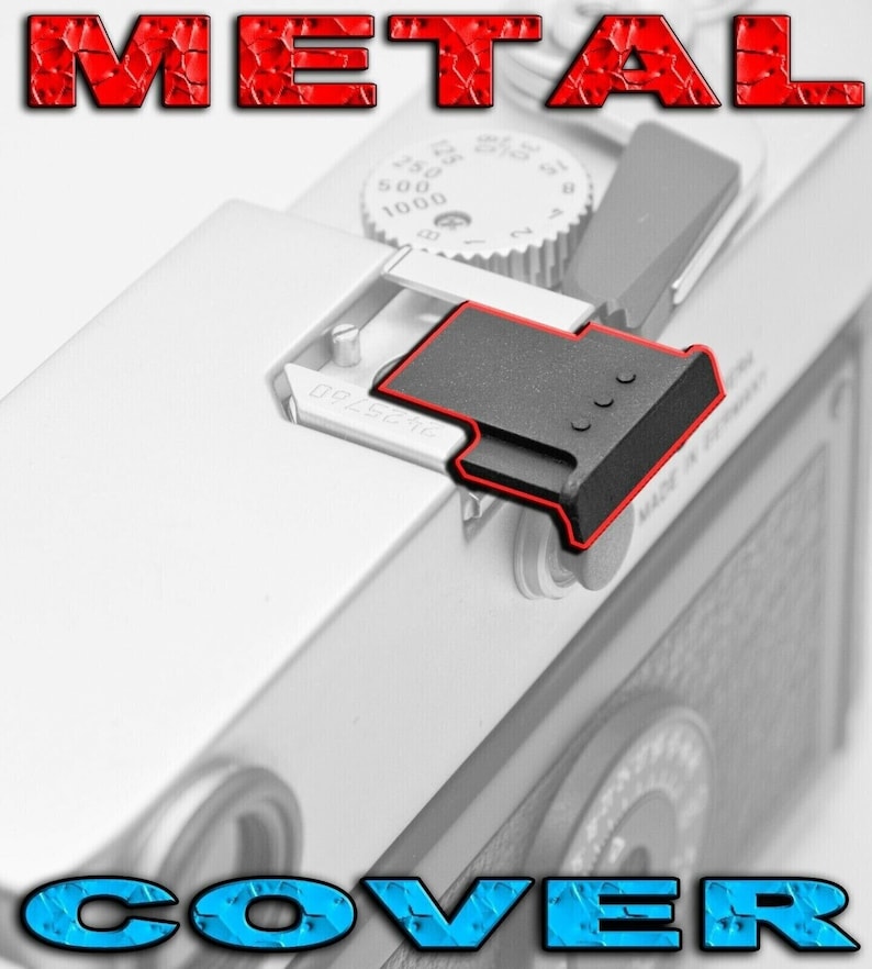 May include: A black metal camera cover with three small holes. The cover is attached to a silver camera body.