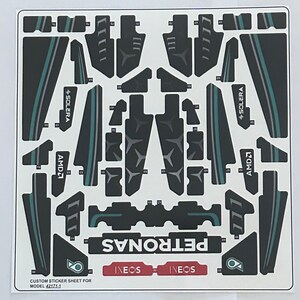 May include: A sticker sheet for a custom LEGO model, featuring the Petronas Formula One team logo, sponsors, and car details. The sheet includes the team's name, Petronas, and sponsors like Ineos, AMD, and Solera.