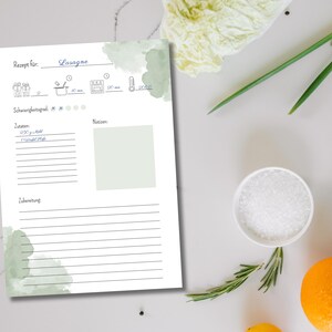 May include: A printable recipe template with a watercolor background in shades of green. The template is titled "Lasagna" and includes sections for ingredients, notes, and instructions.