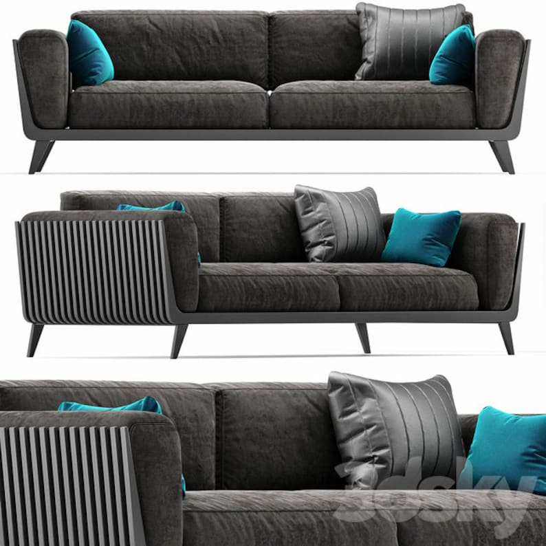 May include: A grey fabric sofa with a slatted wood armrest and black legs. The sofa has two blue throw pillows and one grey throw pillow.