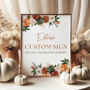 May include: A printable sign with a gold frame and a white background. The sign features a floral design with orange, white, and green flowers. The text on the sign reads "Editable Custom Sign Design, Download & Print".