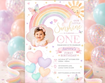 May include: A first birthday invitation card featuring a watercolor rainbow, a smiling sun, butterflies, and heart-shaped balloons. The text reads: Our Little Sunshine is turning one, Aurora's first birthday, Saturday 18th October 2026, 2:00pm-4:00pm.