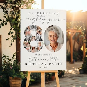 May include: A white sign on a wooden easel, with the words "Celebrating eighty years" in elegant script. The number "80" is formed with photos, and a portrait of a woman is on the right. The sign reads "Welcome to Catherine's 80th Birthday Party".
