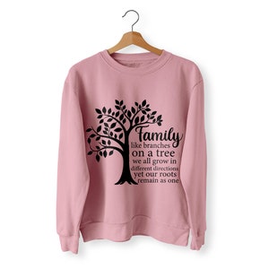 Pu&ograve; includere: Una felpa rosa con un grafico di un albero nero e il testo "Family like branches on a tree we all grow in different directions yet our roots remain as one".