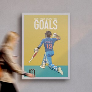 May include: A yellow and teal poster with a cartoon illustration of a cricket player in a blue uniform with the number 18 on the back. The text on the poster reads "I don't follow dreams, I hunt goals".