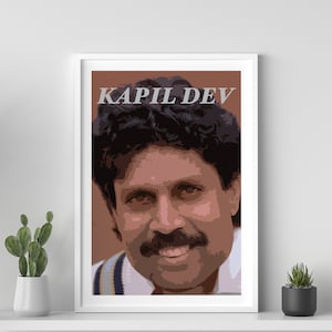 May include: A framed poster featuring a portrait of Kapil Dev, a famous Indian cricketer. The poster has a brown background with the text "KAPIL DEV" in white letters.