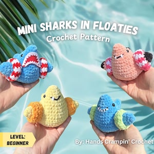 May include: A crochet pattern for mini sharks in floaties. The image displays four handmade crochet sharks in blue, pink, yellow, and blue. Each shark has a floatie. The image text reads "MINI SHARKS IN FLOATIES Crochet Pattern" and "LEVEL: BEGINNER".