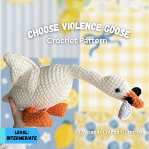 May include: A crocheted white goose with orange feet and a black and orange beak. The goose has blue eyes and is holding a white object in its beak. The text "CHOOSE VIOLENCE GOOSE Crochet Pattern" is displayed above the goose.