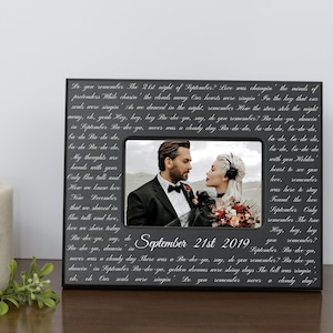 May include: A black picture frame with a white inscription and a photo of a couple. The inscription reads "Do you remember The 21st night of September? Love was changin' the minds of pretenders While chasin' the clouds away Our hearts were ringin' In the key that surr sends were singin' shs we danced in the might, remember How the stars stele the night away, oh, yeah Hey, hey, hey Ba-dee-ya, say, do you remember? Ba-dee-ya, dancin' in September Ba-dee-yo, never was a cloudy day Ba-de-da, ba-da-da, ba-du-da. ba-du Ba da da, ba-du Ba-du-da, My thoughts are hands with your Only blue tall and How we knew leve New December that we shared in blue talk and love, leeve we share today ba-da, ba-da-da, ba-du, ba-du-da with you Holdin' heart to see you leeve, remember was here to stay Found the leve September Only remember The true Hey, hey, hey you remember? remember? Ba-dee-yn. She de September 21st 2019 Ba-dee-ya, dancin'in never was a cloudy day There was a Ba-dee-ya, say, do you remember? Ba-dee-ya, golden dreams were shiny days The bell was ringin'. ch, ch Car sems were singin' Do you remember never a cloudy day?"