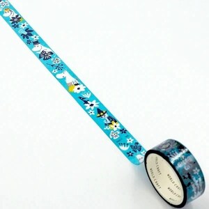 A roll of blue and white patterned tape with various designs, including flowers, snowflakes, and other winter-themed elements, is lying on a white surface.