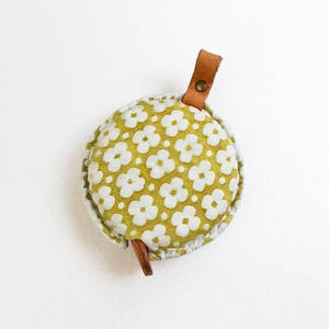 a green and white flowered coin purse