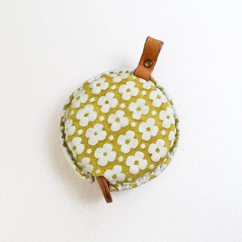 a green and white flowered coin purse
