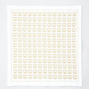 May include: A square white textile featuring a repeating grid pattern of small, mustard-yellow embroidered outlines of cat faces. The entire design is framed by a single, continuous mustard-yellow stitched border along the edges of the fabric.