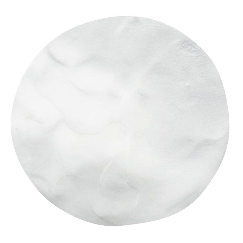 A white circular shape with a textured, wavy appearance.