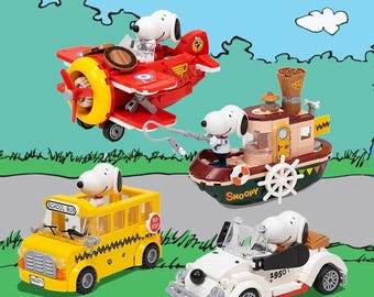 May include: A collection of Snoopy-themed toy vehicles, including a red airplane, a yellow school bus, a white convertible, and a brown and green boat. Each vehicle features a Snoopy figure as the driver or captain.