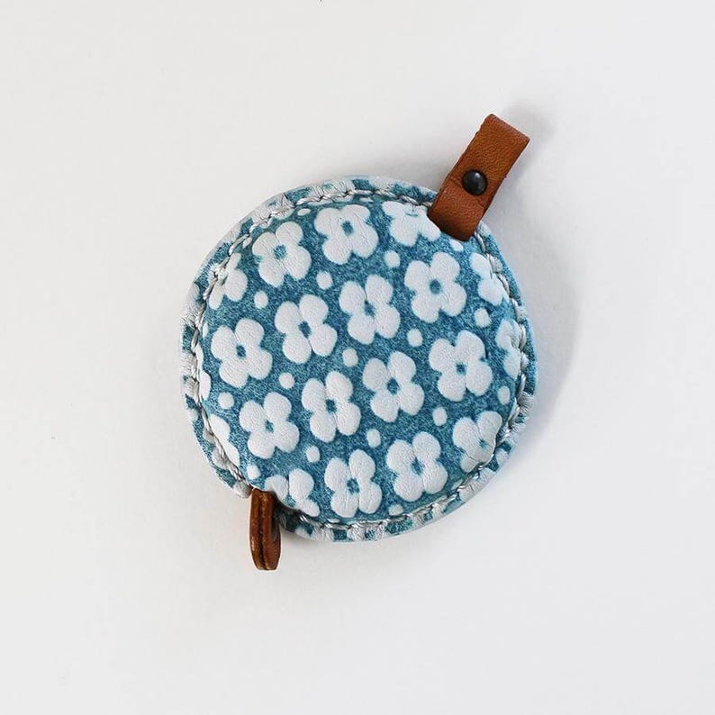 a blue and white flowered coin purse