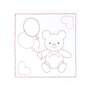 May include: A white fabric square featuring a red dashed-line border and a central embroidered design of a teddy bear wearing a bow tie. The bear holds two balloons, and there are two heart outlines in the corners, all stitched in red thread.
