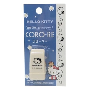 May include: A Hello Kitty stamp in a blue package. The stamp is rectangular and features the Hello Kitty logo. The package has the text "HELLO KITTY" and "CORO-RE". The stamp is cream-colored and has a clear plastic cover.