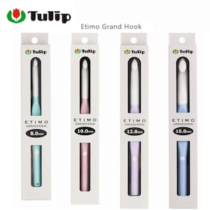 May include: Four Etimo Grand Hook crochet hooks in their packaging. The hooks are white with colored handles in shades of blue, pink, and purple. The packaging includes the Tulip logo and hook sizes: 8.0mm, 10.0mm, 12.0mm, and 15.0mm.