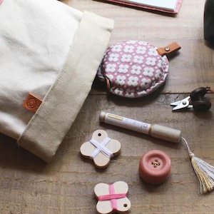 a wooden table topped with lots of crafting supplies
