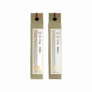 May include: Two rectangular packages of Japanese sewing needles. The packages are light green with a white label and Japanese text. The top of each package has a small hole and a red string. The text on the label reads "Big Eye Straight".