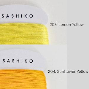 two spools of thread, each with a different color: yellow and yellow. The spools are labeled with the text "SASHIKO" and "SUNFLOWER YELLOW" respectively.
