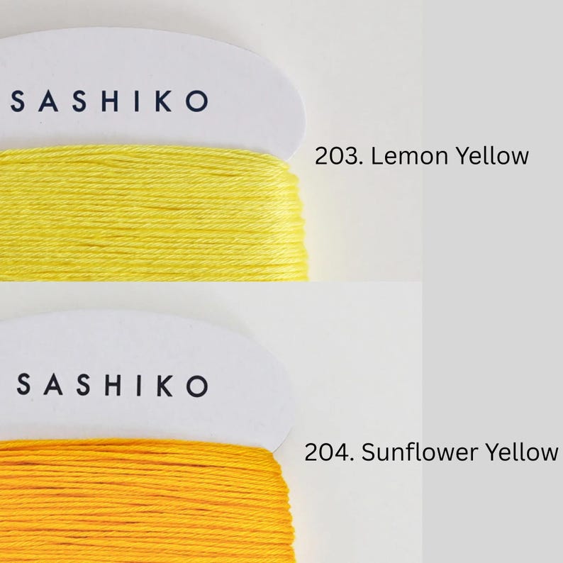 two spools of thread, each with a different color: yellow and yellow. The spools are labeled with the text "SASHIKO" and "SUNFLOWER YELLOW" respectively.