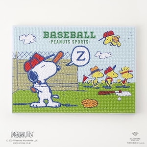 May include: A diamond painting kit featuring Snoopy wearing a red baseball cap and holding a bat, with the text BASEBALL PEANUTS SPORTS and a speech bubble with the letter Z. The scene includes yellow birds, a fence, and a baseball bat on grass.
