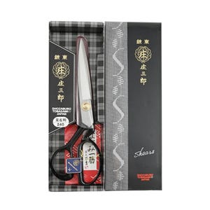 May include: A pair of Shozaburo Tobasami shears in a decorative box. The shears have black handles and silver blades. The box is black and features Japanese text and gold accents. The shears are 240 mm in length.