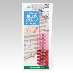 May include: A package of Clover brand sewing clips. The package contains ten mini clips in red and pink. The text on the package says "Sewing Clips" and "Mini 10 pieces".