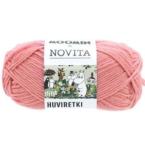May include: A ball of pink yarn with a label featuring the text "MOOMIN x NOVITA" and the word "HUVIRKETKI". The label has illustrations of cartoon characters. The yarn is a solid, light pink color.