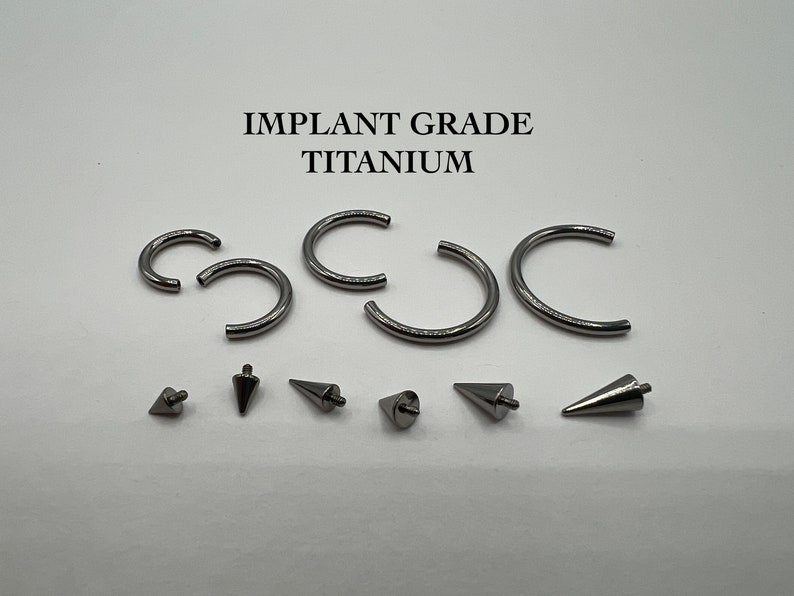 May include: A set of titanium body jewelry, including five circular hoops and six cone-shaped studs. The jewelry is made of implant grade titanium and is suitable for piercings.