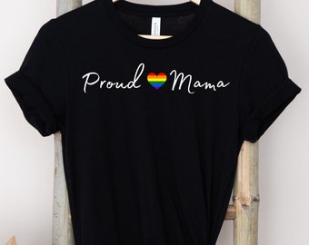May include: Black t-shirt with the text "Proud Mama" in white lettering and a rainbow heart.