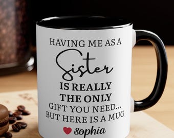 May include: White ceramic mug with a black interior and handle. The mug features the text "HAVING ME AS A Sister IS REALLY THE ONLY GIFT YOU NEED... BUT HERE IS A MUG" with the name "sophia" below.