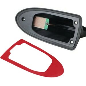 May include: A black shark fin antenna with a red adhesive sticker. The antenna has a small green circuit board inside.