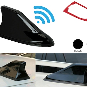 May include: Black car antenna fin with a shark fin design. The antenna is shown on a car and on a white background. The antenna is also shown with a wireless signal icon. The antenna is available in black and carbon fiber finishes.