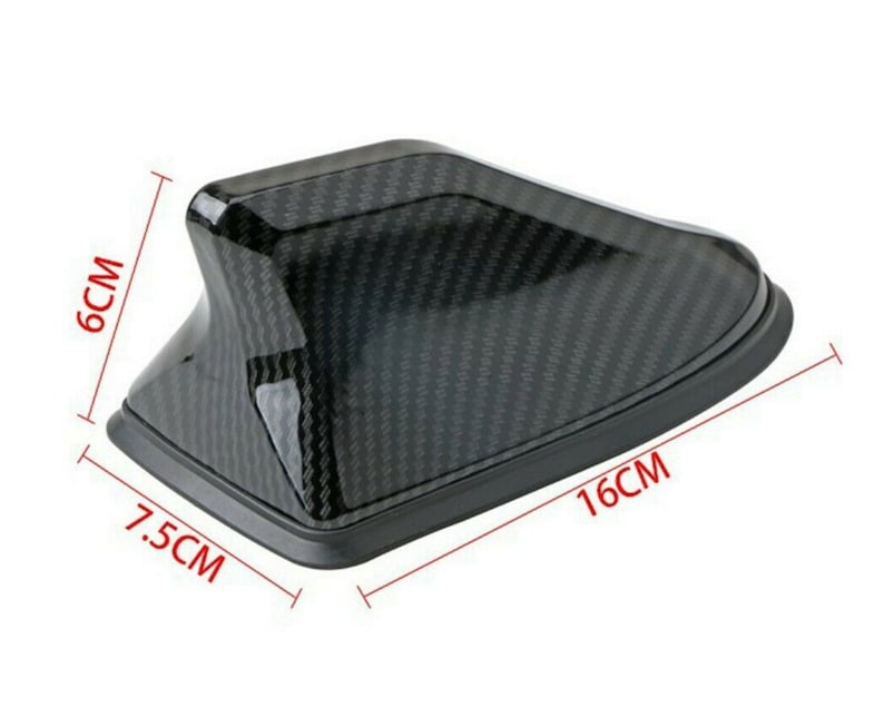 May include: Black carbon fiber car antenna fin with a 7.5 inch by 16 inch measurement.