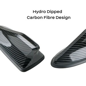 May include: Two black carbon fiber car antenna toppers. The text "Hydro Dipped Carbon Fibre Design" is above the image.