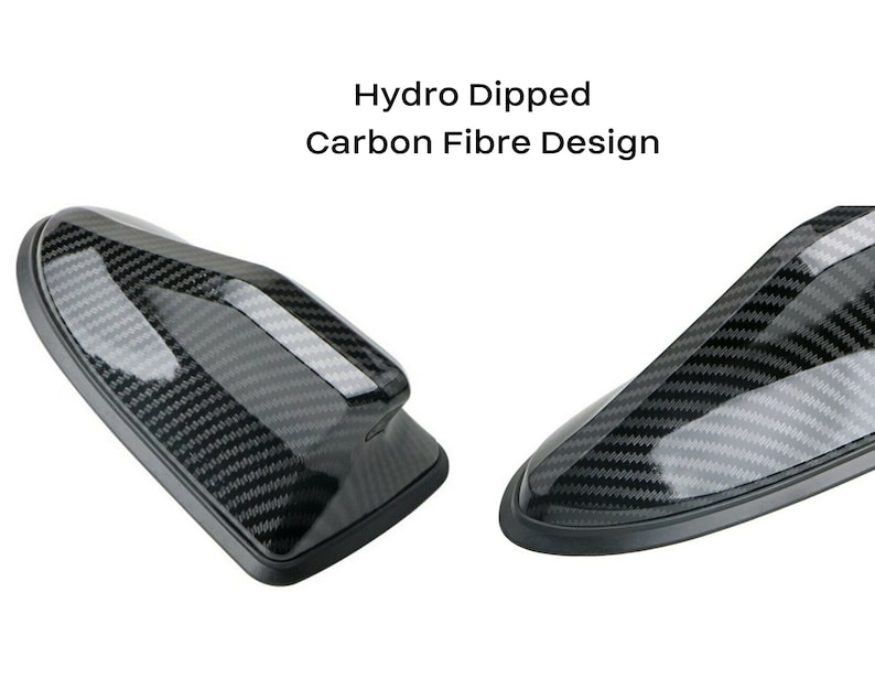 May include: Two black carbon fiber car antenna toppers. The text "Hydro Dipped Carbon Fibre Design" is above the image.