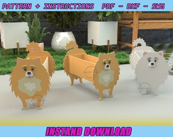 May include: Three wooden planter boxes shaped like Pomeranian dogs. The planters are in different colors: orange, white, and brown. The text "INSTAND DOWNLOAD" is at the bottom of the image.