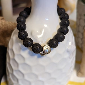 Stretchy bead bracelet, 10mm black lava rock beads, silver skull spacer